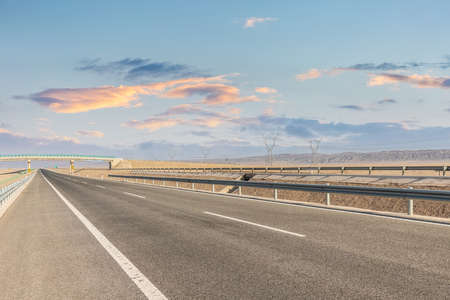 highway landscape at dusk, western open road sceneの写真素材