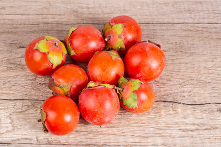 persimmons on wooden table background, autumn fruit, top viewの写真素材