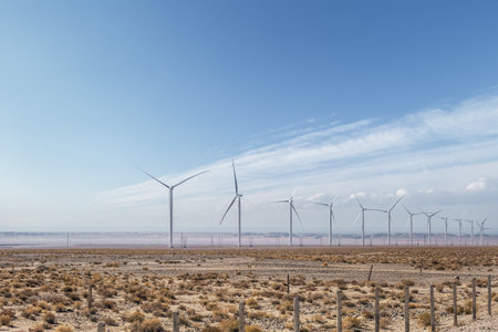 wind farm on desert wilderness in autumn, clean energy landscape against a blue skyの写真素材