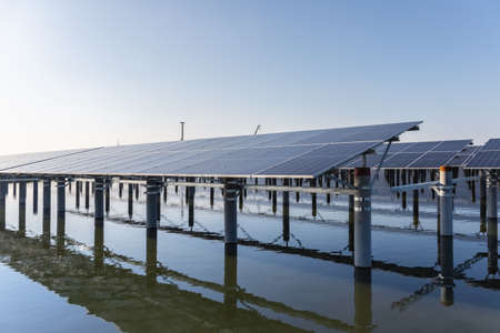 rows of solar panels on the fishpond, new energy landscape, development and utilization of natural resources in countrysideの写真素材