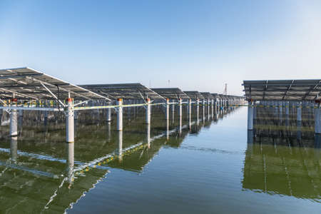 pond culture and clean energy, solar panels on the fishpondの写真素材
