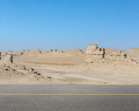 road with wind erosion landscape, western wilderness background, qinghai province, China.の写真素材