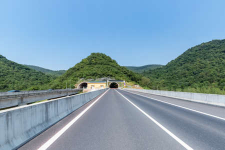 entrance of highway tunnel, road backgroundの写真素材