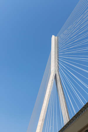 cable-stayed bridge close-up, main tower and steel cables, view from under the bridgeの写真素材