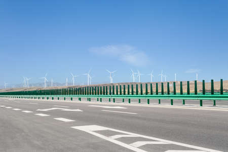 modern highway with wind farm on western wildernessの写真素材