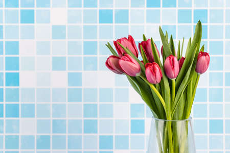 beautiful tulips flower with blue mosaic tile backgroundの写真素材