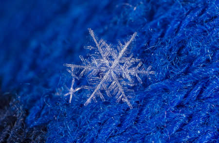 natural snowflakes on a knitted mittenの写真素材
