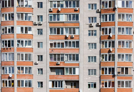 Wall of a residential block of flats with balconies windows