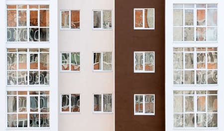 Wall of a residential block of flats with balconies windows