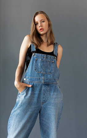 young woman in denim overalls, studio shooting