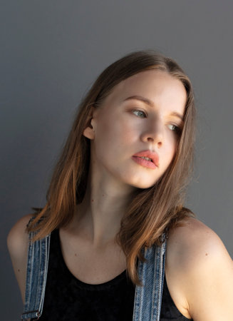 young woman in denim overalls, studio shooting