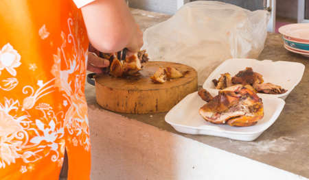 Chef chopping chicken foam box.の写真素材