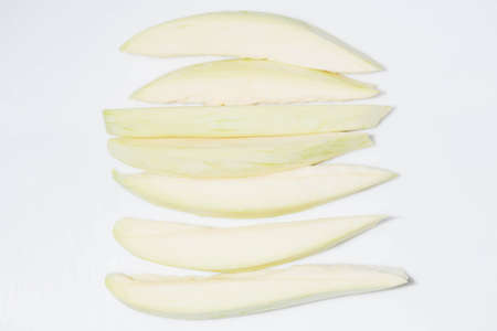 Mangoes are chopped on a white background.の写真素材