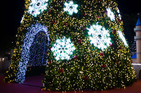 Christmas tree lights out of focus outdoors at night.の写真素材