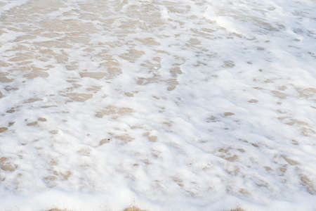 Sea foam on the beach the waves.