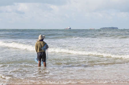 Fishermen were sown nets fish on the beach.の写真素材