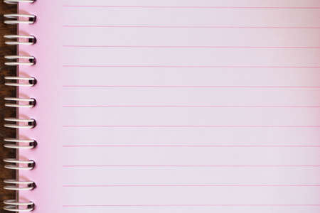 Pink notebook on the wooden floor.の写真素材