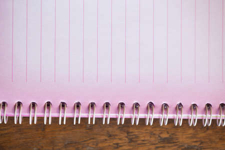 Pink notebook on the wooden floor.の写真素材