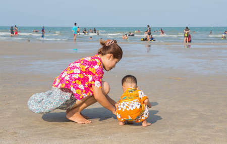 Mother and child playing on the beach.の写真素材