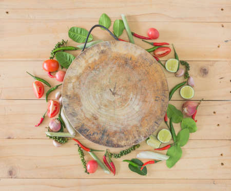 Tom Yum spices and chopping board on a wooden floor.の写真素材