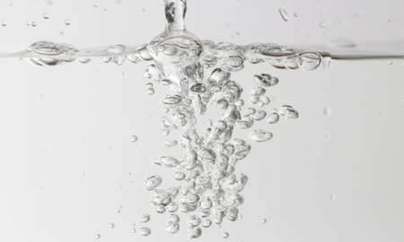 Bubbles in the water on a white background.の写真素材