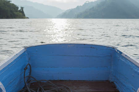 Rowboat floating on the dam in the morning.の写真素材