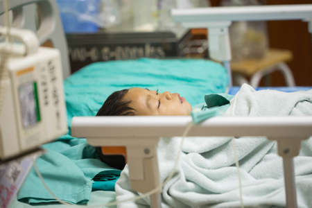 Pediatric patients lying on the bed.の写真素材