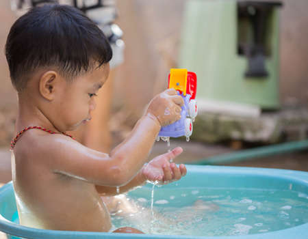 Child bathing in the baby bath.の写真素材