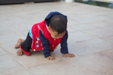 Child crawling on the floor tiles.の写真素材