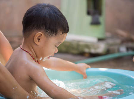 Child bathing in the baby bath.の写真素材