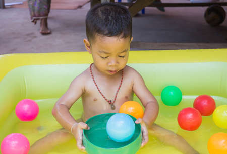 The child is sitting in the bathtub.の写真素材