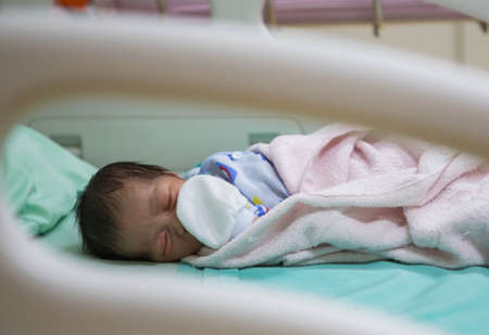 Newborns are sleeping on patient beds.の写真素材
