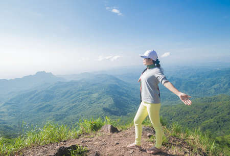 Woman standing on Phu Thap Boek.の写真素材