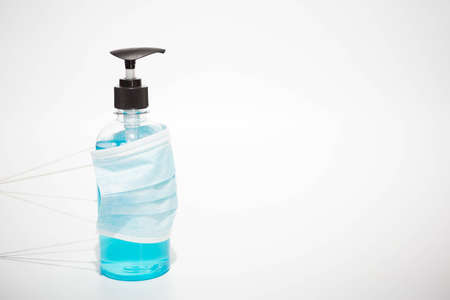 Alcohol gel and Face Masks on a white background.の写真素材