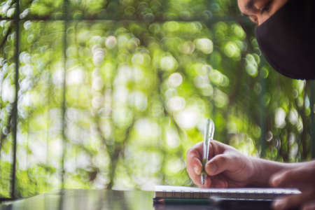 A man working on a wooden tableの写真素材