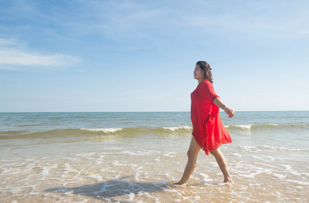 Woman walking on the beach.の写真素材