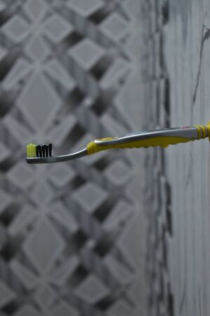 kids tooth brush placed horizontally on the wallの写真素材
