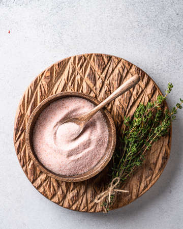 pink Himalayan salt in a bowl on a light background. Top view, place for textの写真素材
