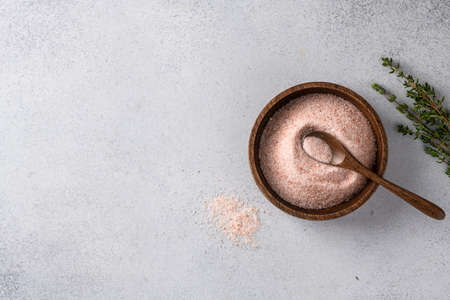 pink Himalayan salt in a bowl on a light background. Top view, place for textの写真素材