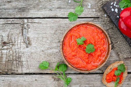 Balkan traditional dish ajvar in bowl on rustic woodenの写真素材