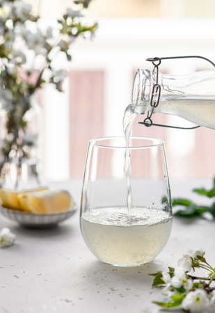 homemade lemonade in a glass on a light backgroundの写真素材