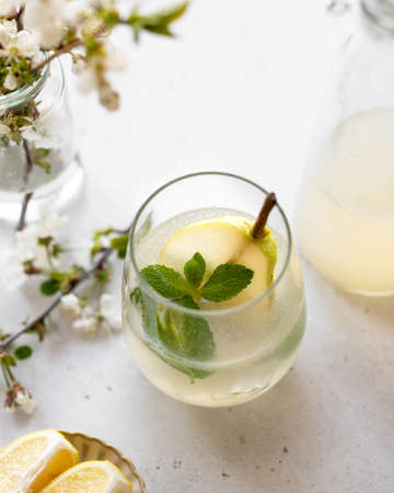 homemade pear lemonade in a glass on a light backgroundの写真素材