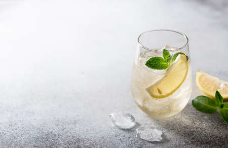 lemonade with ice in a glass on a light background, copy spaceの写真素材