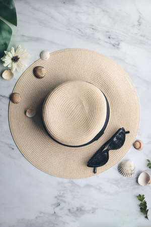 Hat, sunglasses and seashells on marbleの写真素材