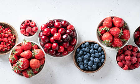 Various fresh summer berries. Strawberries, raspberries, blueberries, cherries, currants on white...
