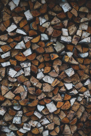 Background of chopped firewood logs in a pileの写真素材