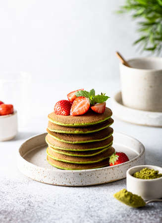 Matcha pancakes in a ceramic plate on a white backgroundの写真素材