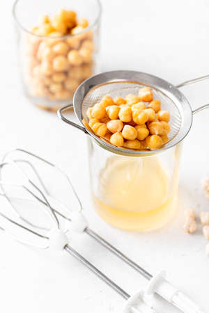 Aquafaba, chickpea water brine draining. Replace egg for vegan recipeの写真素材