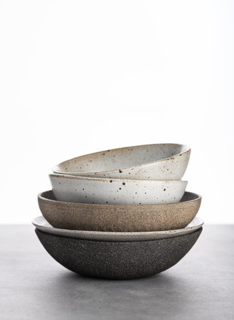 handmade ceramics, empty craft ceramic bowls on light backgroundの写真素材