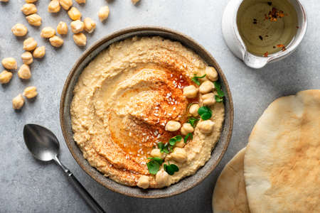 hummus in a ceramic bowl on a light background, top viewの写真素材